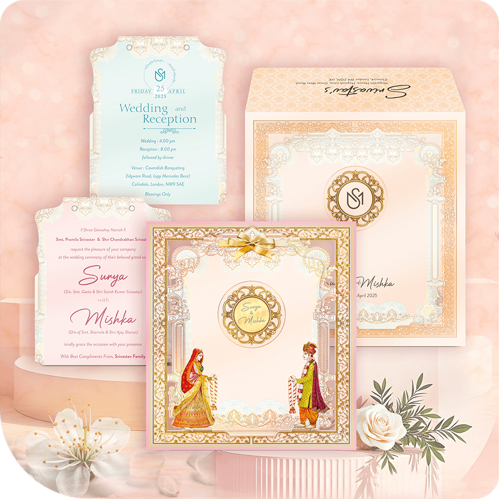 Luxury MDF wedding invitation suite with traditional Hindu bride and groom figures, pastel pink/peach border, and intricate gold foil pattern.