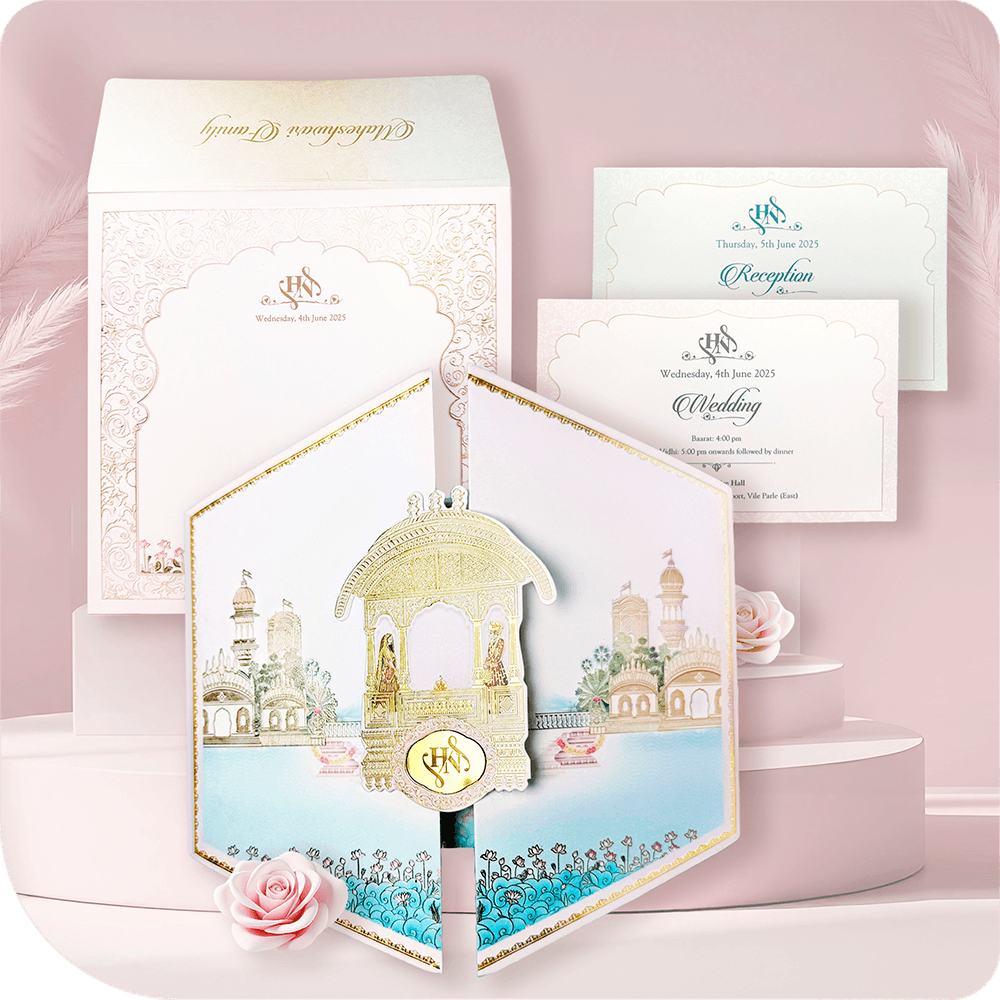 Discover the perfect blend of luxury and elegance with this Hexagon Folder Wedding Card. Featuring a unique door-style design, this sky-blue invitation with a soft pink border is adorned with intricate gold foil artwork and a stunning golden acrylic mirror emblem. The card opens vertically to reveal two premium inserts, designed to elegantly present your wedding details. Ideal for royal, destination, and luxury weddings, this card is a statement piece of sophistication and grandeur.