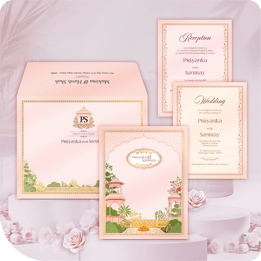 Luxury Haveli Garden Destination Wedding Invitation Card with printing. Pastel pink folder suite featuring traditional Indian palace architecture, arch window, and lush floral illustration. Includes Wedding and Reception insert cards and a monogrammed envelope. Premium royal Indian wedding stationery. Full custom printing service included.