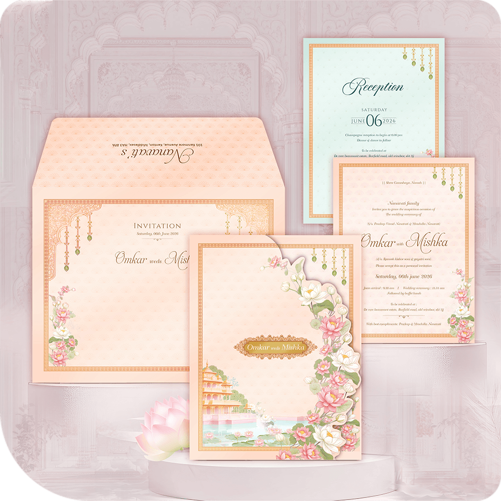 Luxury Udaipur Lakeside Palace Wedding Invitation Card with printing. Destination wedding suite featuring a Pichwai-inspired illustration of a palace and pink lotus flowers in a peach and mint green folder style. Includes Wedding and Reception insert cards and a custom envelope. Premium royal Indian wedding stationery. Full custom printing service included.